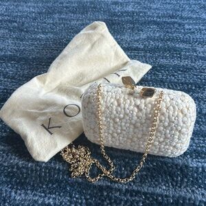 Kotur clutch bag with gold chain. Cream floral pattern overlaid on gold body